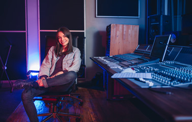 Female music composer at sound recording studio