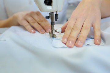 worker sewing a fabric