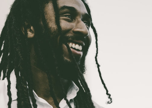 Smiling Young Man with Dreadlocks