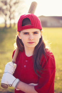 Portrait of young girl holding baseball bat