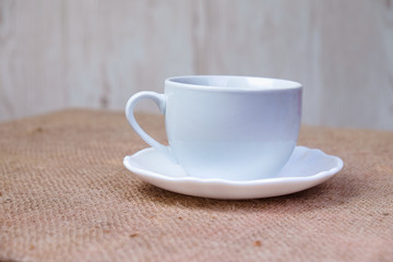 White cup  on wooden table