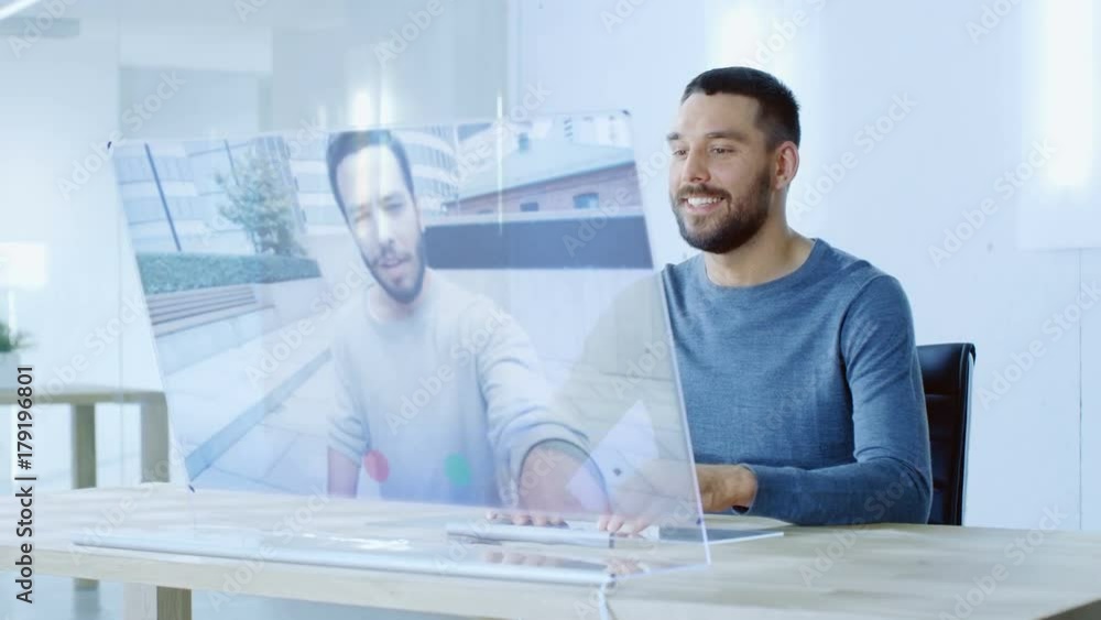 Poster in the near future man makes video call from computer with transparent display to his friend. they h