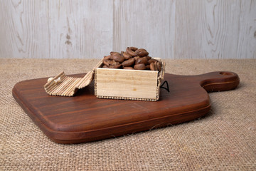 Coffee beans on wooden cutting board . Relax time concept.