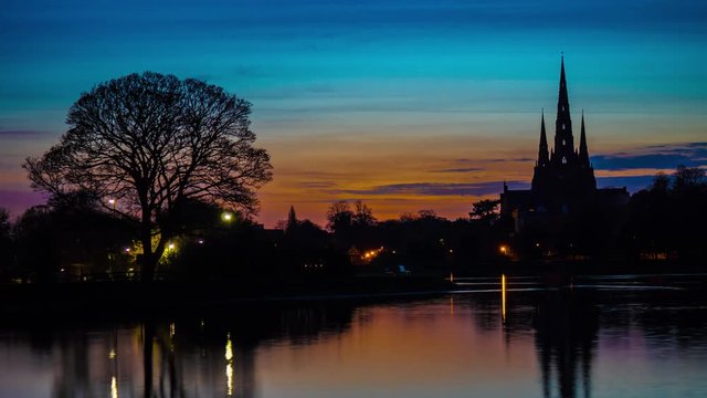 Timelapse colourful clouds at sunset over Lichfield City Cathedral Midlands silhouette, England November 2017