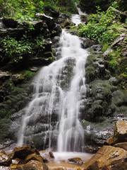 Obraz premium Waterfall at the carpatian mountains green forest