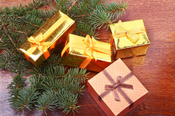Fototapeta na wymiar Christmas decoration with gift boxes, christmas tree on a wooden desktop.