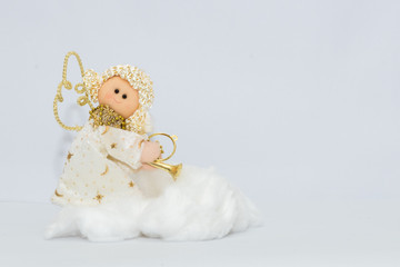 White and golden christmas angel with white background and a cloud