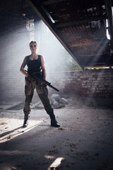 A girl with a submachine gun fires