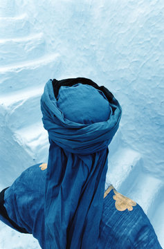 Moroccan Touareg standing by blue steps. Morocco