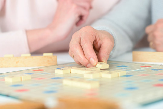 Elderly woman playing a board game
