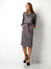 Young beautiful woman posing in new fashion gray winter dress full body