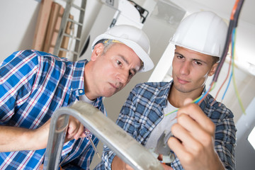 mentor supervising male electrical engineer