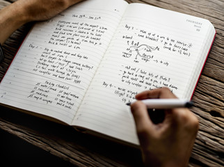 Closeup of hands writing travel plan