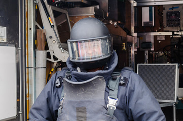 Man wearing bomb-proof suit and helmet as used by bomb squad ATOs.
