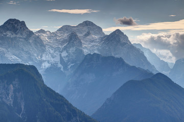 Highest peak of Slovenia the mighty snow covered Triglav towering over Rjavina, Begunjski vrh and Cmir north faces and steep glacial Kot Valley in blue mist, Triglav National Park, Julian Alps, Europe © nogreenabove2k