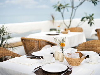 Set tables at an outdoor restaurant