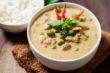 Thai food (Panaeng curry),red curry with pork and cooked rice in a bowl on wooden background