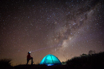 Man, tent and so many stars