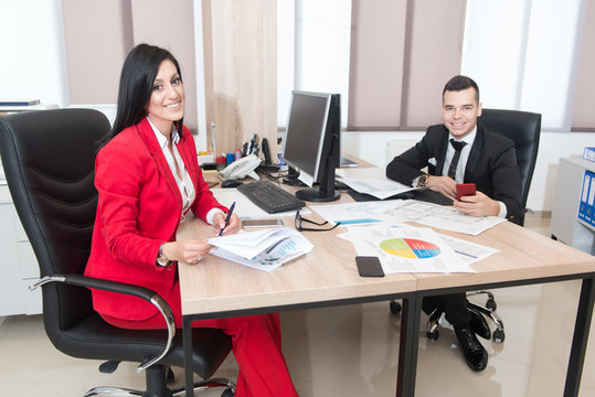 Businessman And Businesswoman Having Discussion In Office