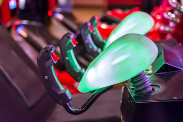 A Line of Joysticks with a Blurred Background in an Arcade