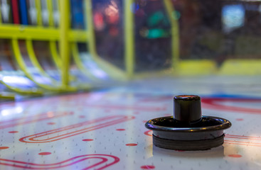 Close up on an air hockey puck on an table