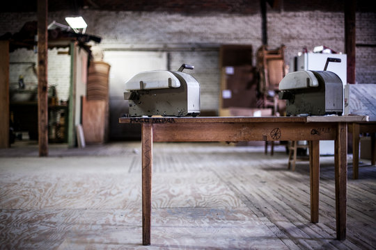 Table with machine atop in workshop warehouse