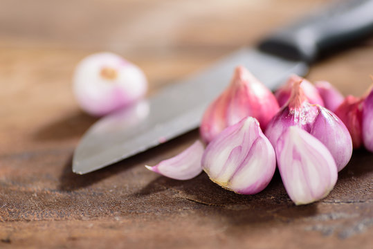 Slice shallots and knife on wooden background for cooking,spice an herb,food ingredient