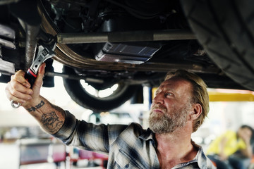 A mechanic fixing a car