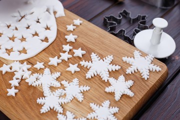 Confectionery mastic decorations in form of stars and snowflakes, close up. Family culinary and New Year traditions concept, Christmas food