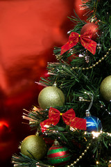 Christmas tree with ornaments and red background (vertical photo)