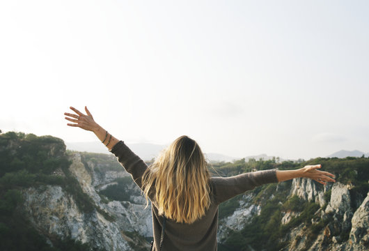 Carefree woman arms outstretched on the mountain