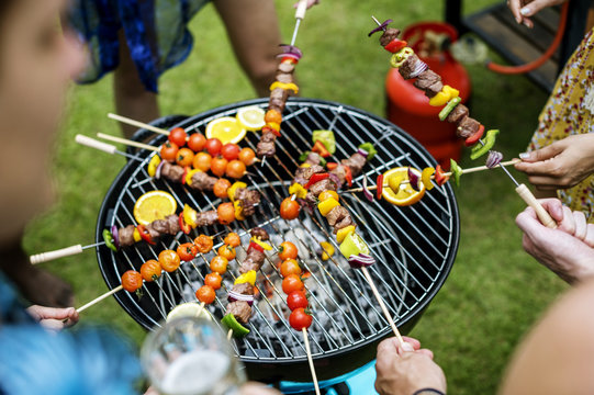 Aerial view of a group of diverse friends grilling barbecue outdoors