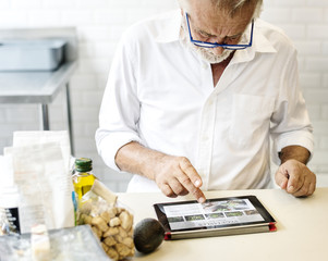 Senior caucasian man using digital tablet