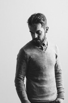 Black and white portrait of a young bearded man.