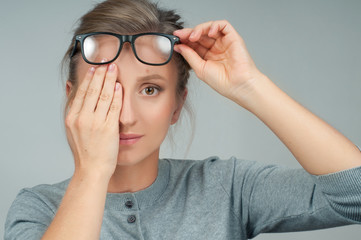 Patient doing an eye checkup. Woman closing her eye