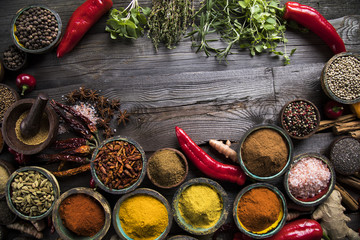 Spices and herbs in wooden bowls. Food and cuisine ingredients