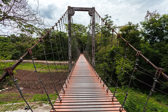 Long rope bridge or suspension bridge in forest at Khao Kradong Forest Park in Buriram Province,THAILAND.