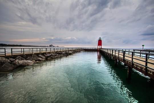 Charlevoix Lake Michigan Lighthouse And Waterfront. The red Charlevoix Lighthouse and waterfront park on the shore of Lake Michigan. 