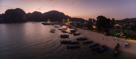 Long-Tail Boats Moored in Ton Sai Bay At Dusk, Phi Phi Islands, Aerial Drone Panorama
