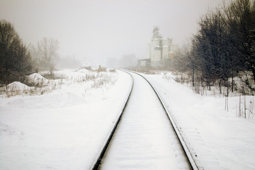 Train tracks and grain silos in snow
