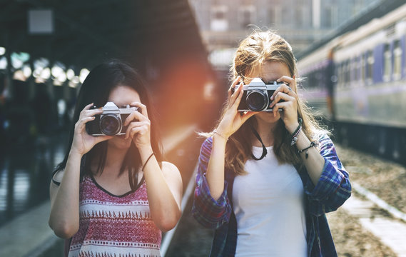 Young women are taking photo with film cameras