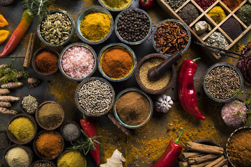 Spices and herbs in wooden bowls. Food and cuisine ingredients