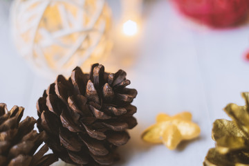 Pine cones and Christmas party accessories on wooden table