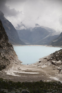 Two tourists as specks in an Andean wilderness