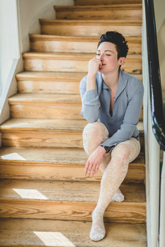 Girl with tights sitting on a stairway