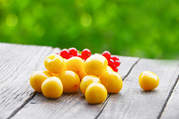 Yellow cherry on a wooden table