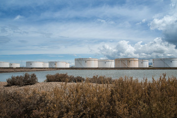 Fototapeta na wymiar Refinery oil tanks, oil industry business