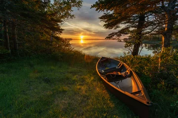 Foto op Canvas Empty canoe at sunset © JONATHAN BUSH
