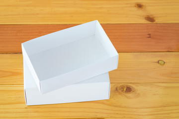 Empty white gift box for mock up on wooden table with copy space.