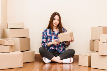 Young woman with cardboard box at home - Business online and delivery concept